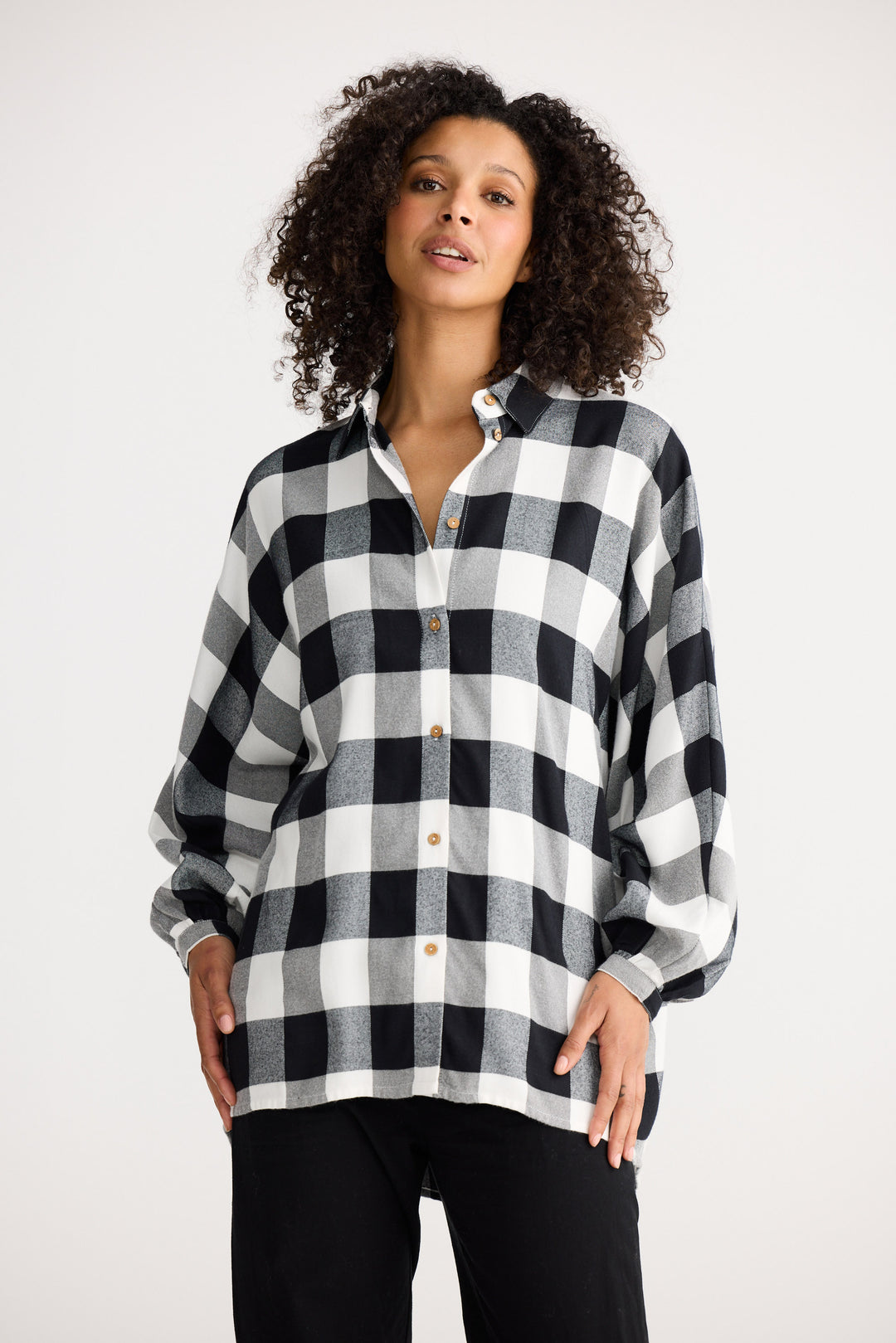 Woman wearing a black and white checkered shirt on a white background