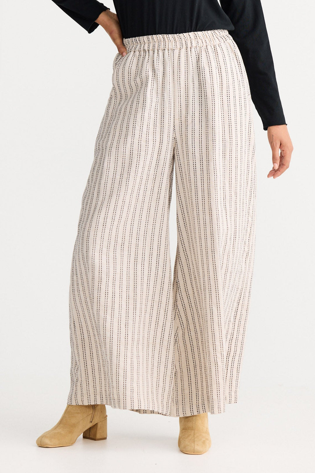 Model wearing natural stitch Positano Pant, angled front view on white background