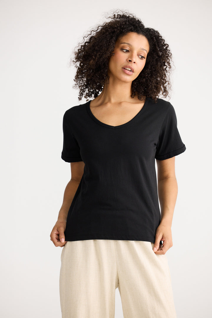 Model wearing black Kasai Short Sleeve Tee, front view on white background