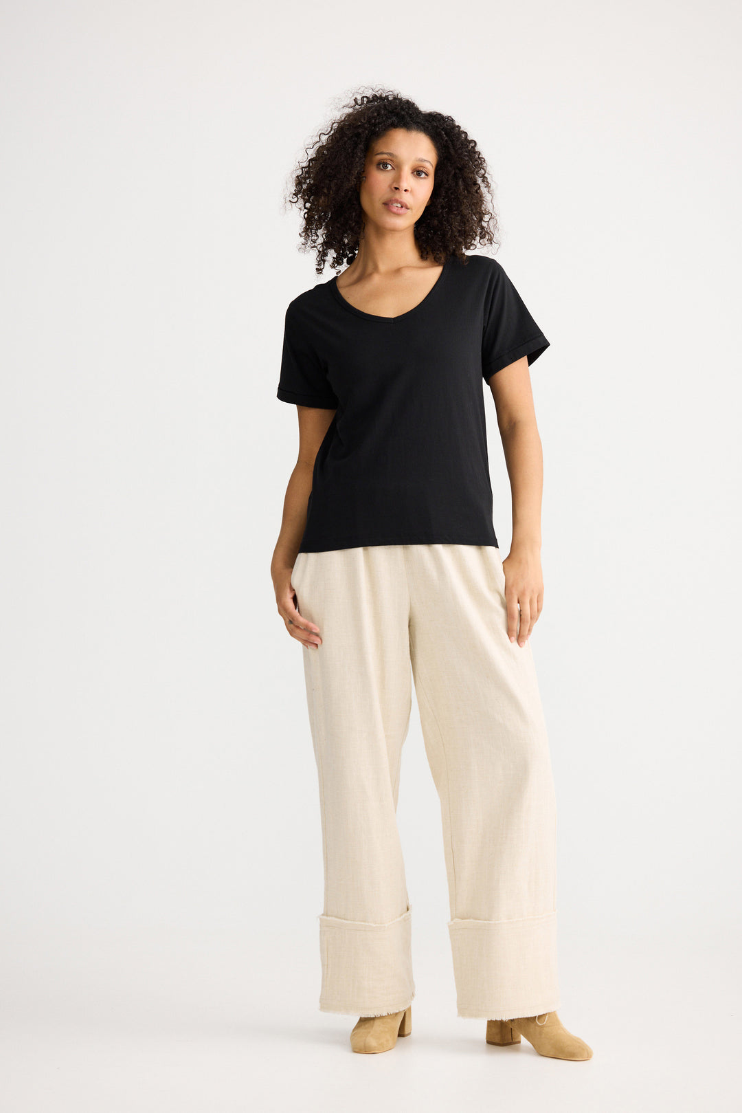 Model wearing black Kasai Short Sleeve Tee, angled front view on white background