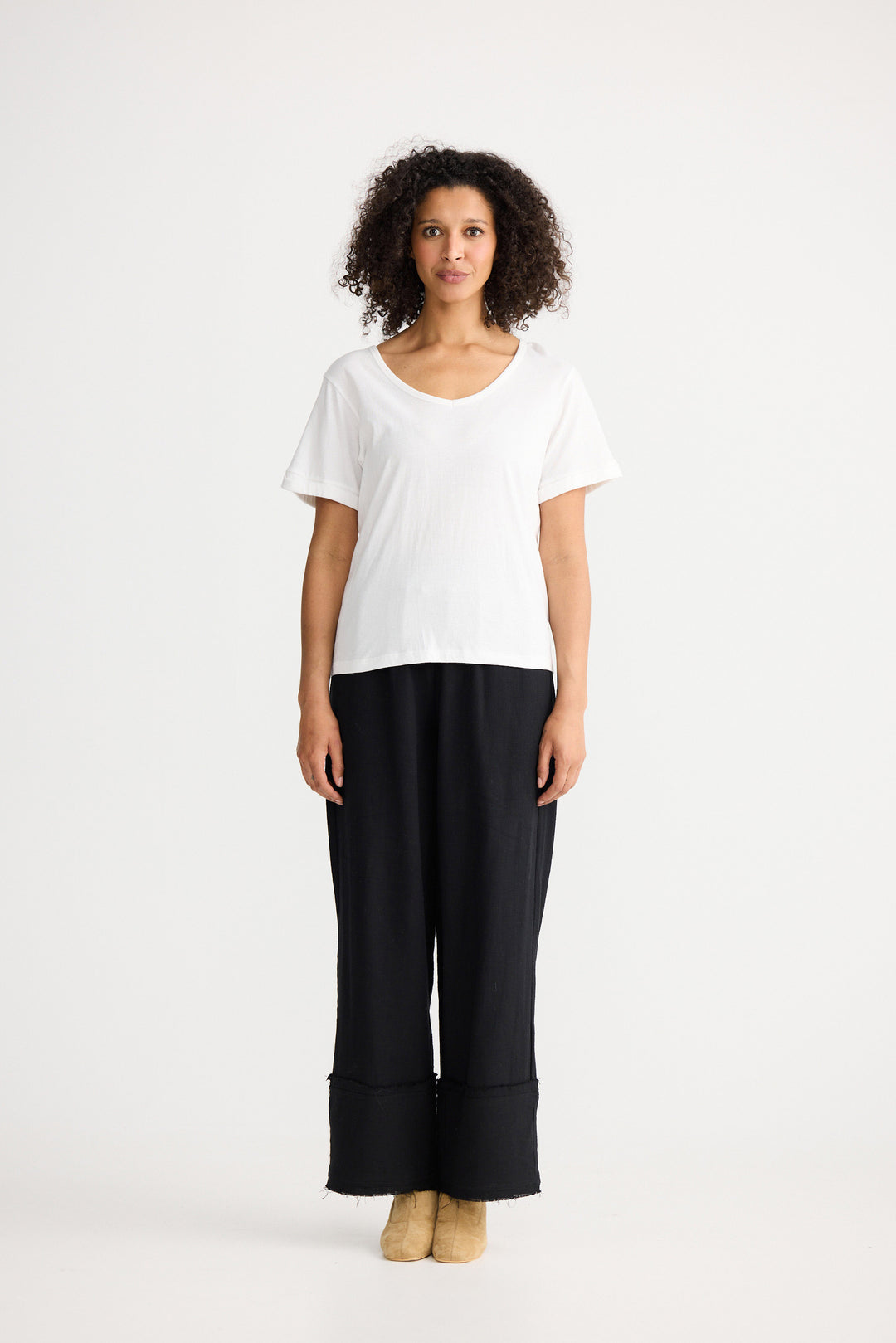 Model wearing ivory Kasai Short Sleeve Tee, angled front view on white background