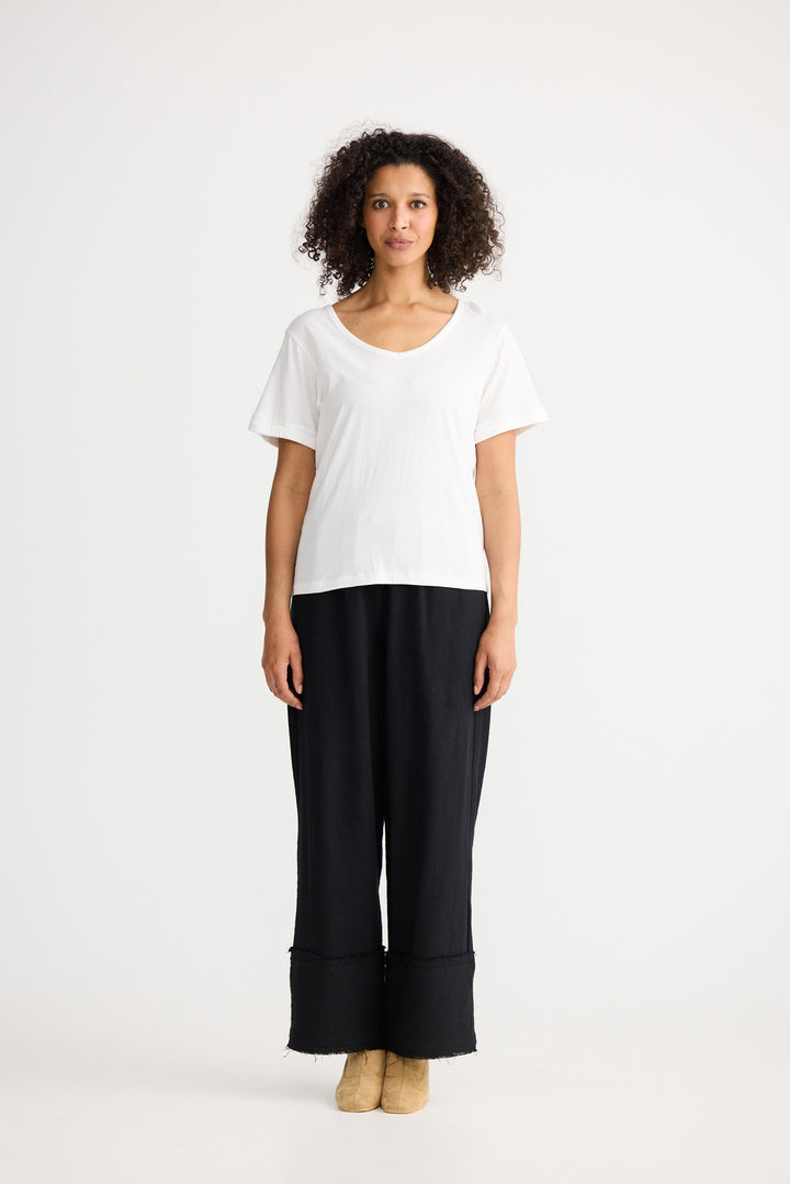 Model wearing ivory Kasai Short Sleeve Tee, angled front view on white background