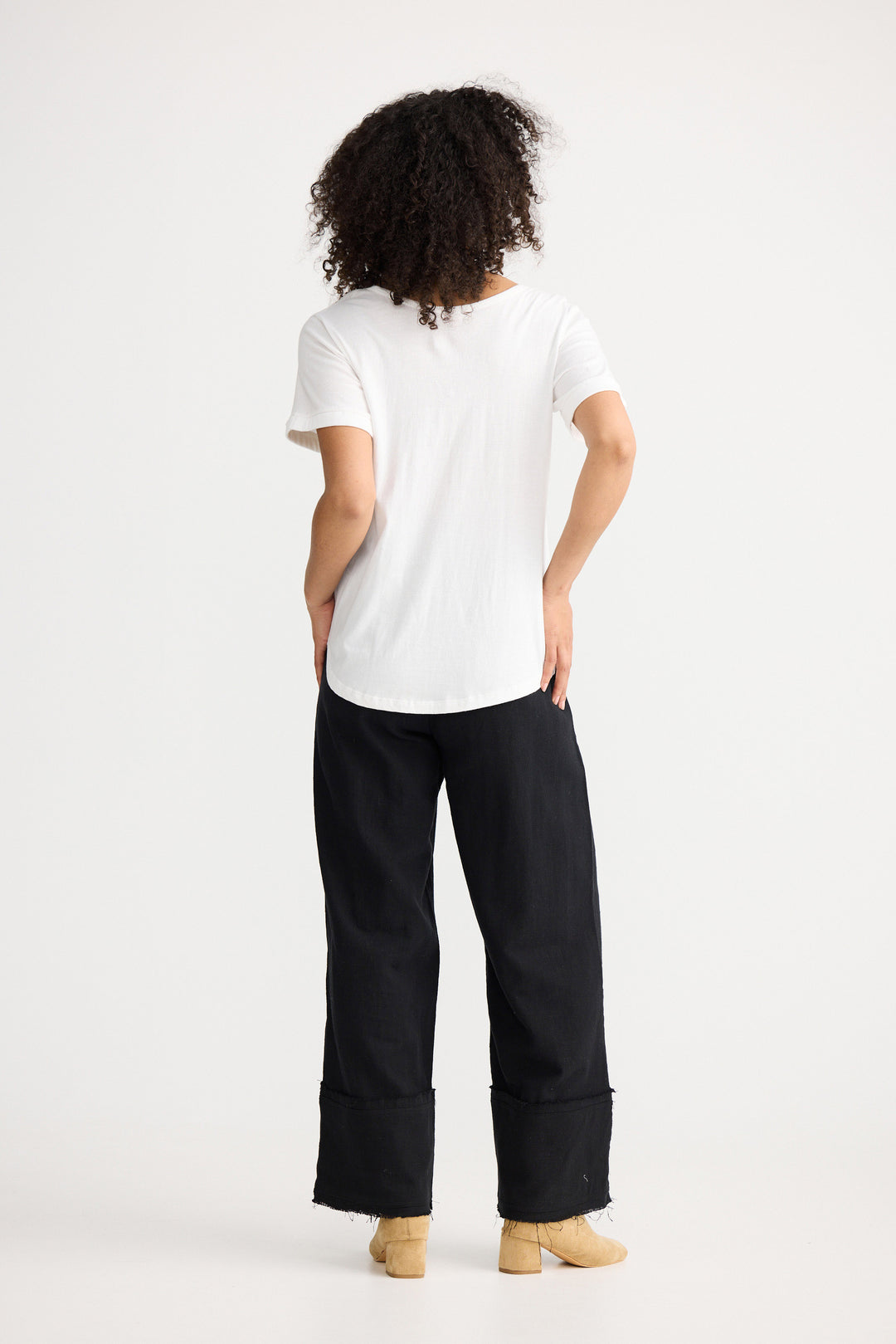 Model wearing ivory Kasai Short Sleeve Tee, back view on white background