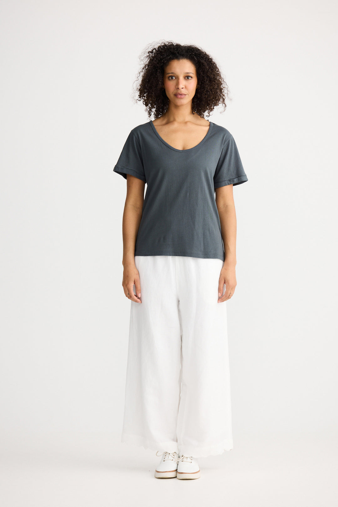 Model wearing slate Kasai Short Sleeve Tee, angled front view on white background