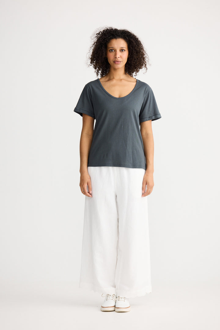 Model wearing slate Kasai Short Sleeve Tee, angled front view on white background