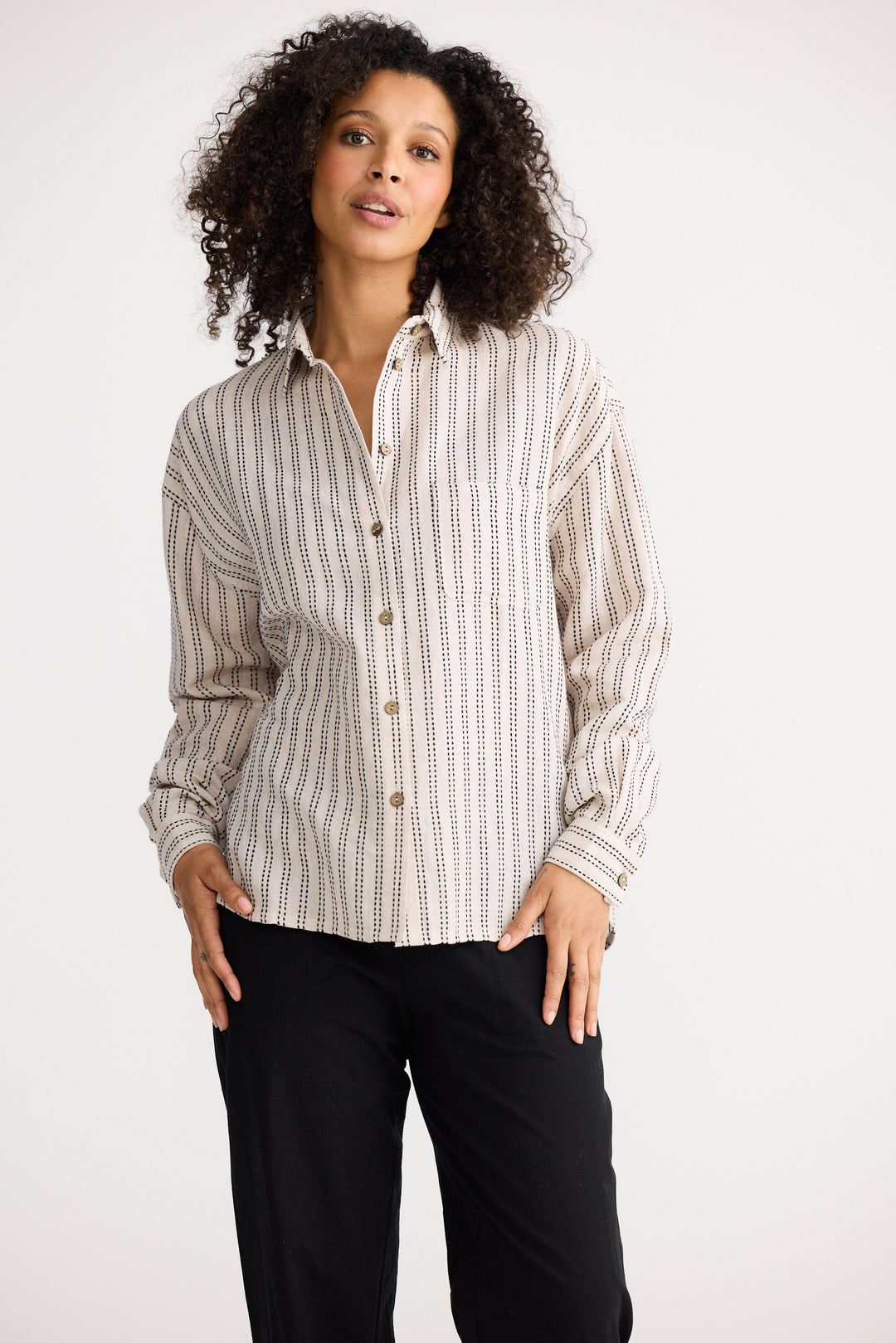 Model wearing natural stitch Morgan Shirt, side view on white background