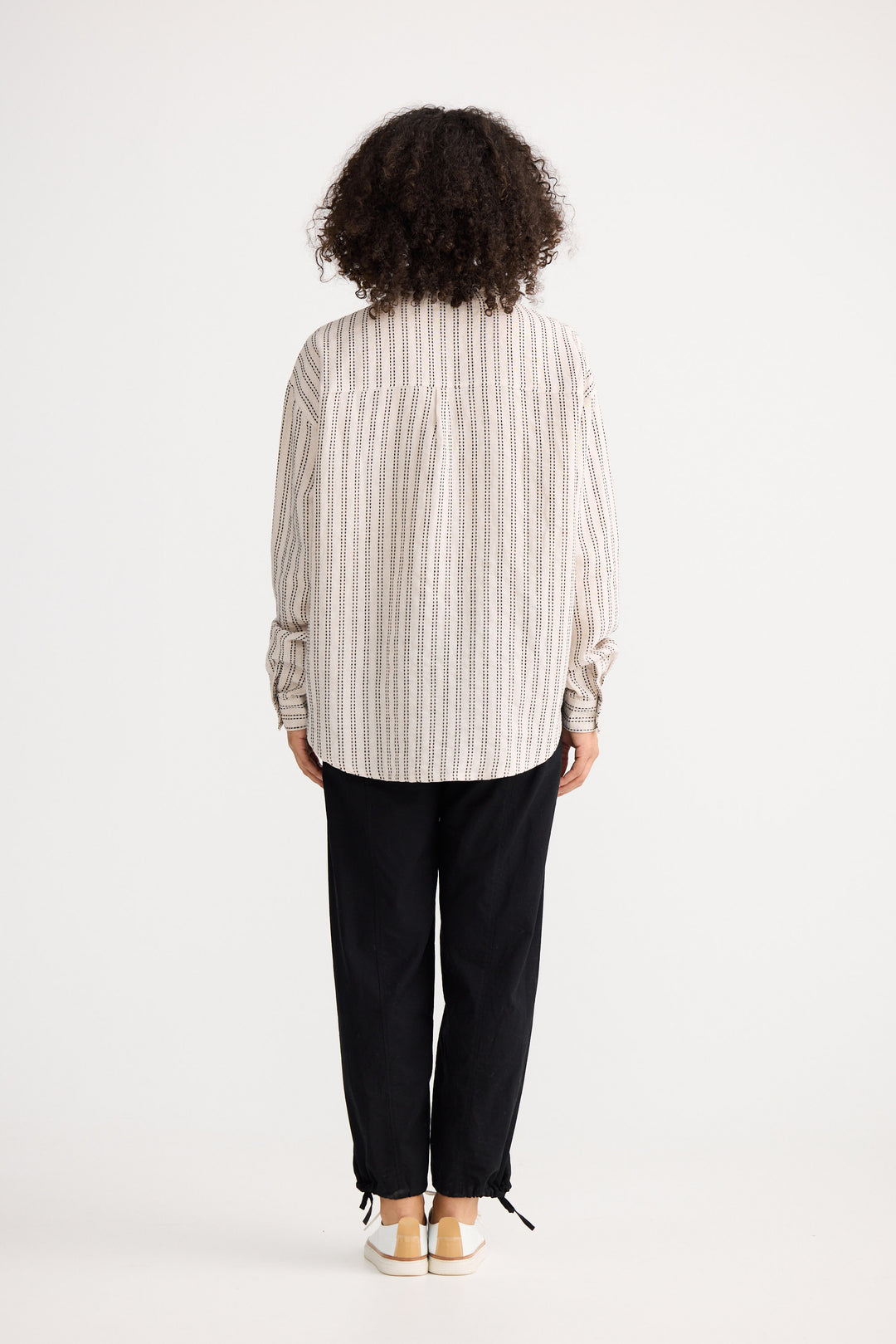 Model wearing natural stitch Morgan Shirt, back view on white background