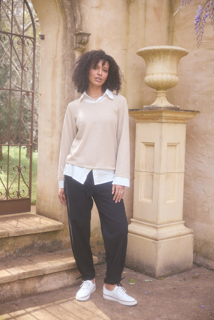 Model wearing natural w white Sorrento Top, lifestyle close-up view