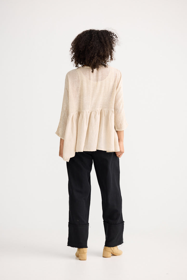 Model wearing natural Nikita Top, front view on white background