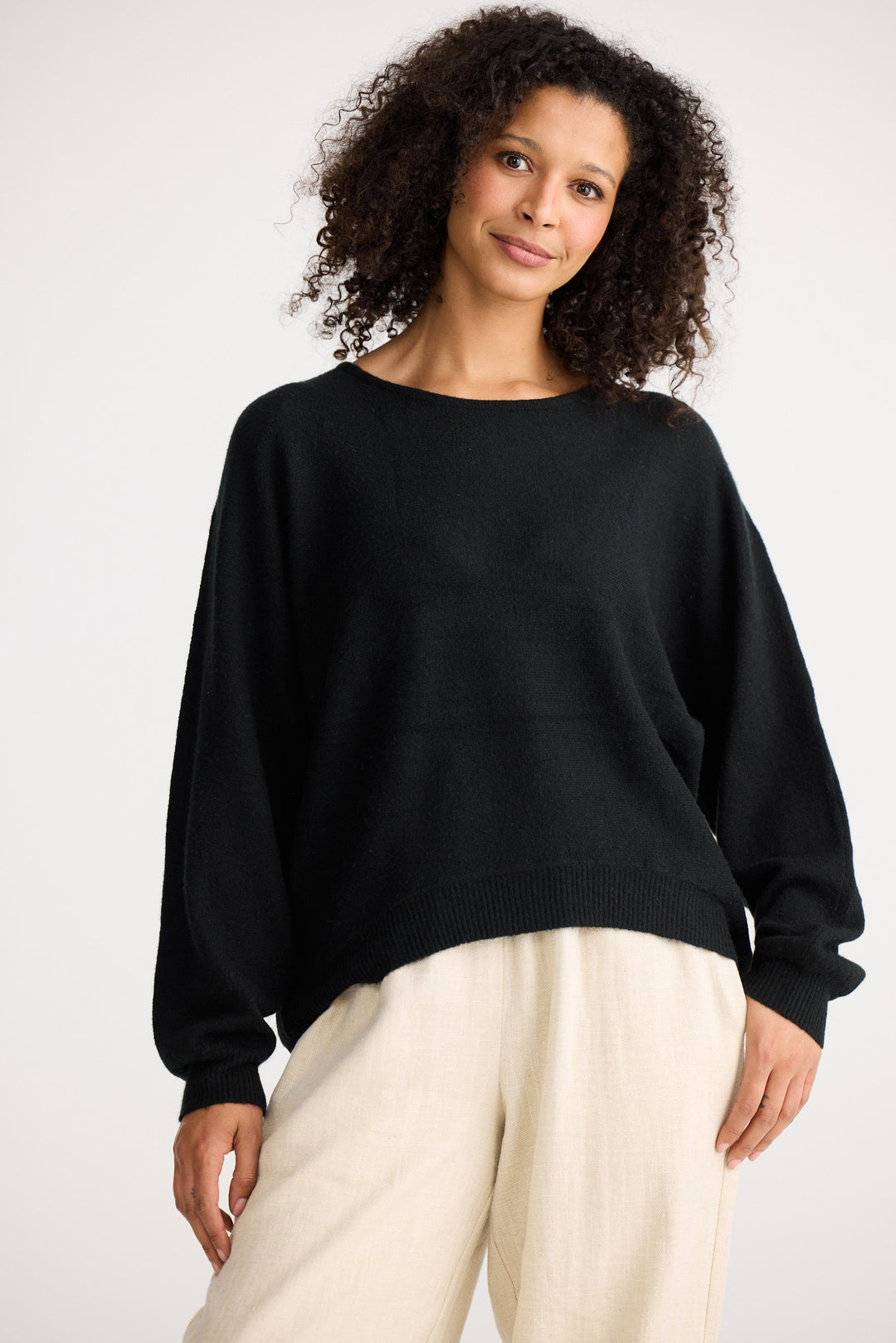 Model wearing charcoal Freddie Knit, angled front view on white background