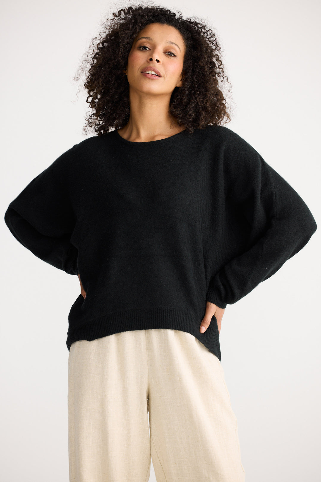 Model wearing charcoal Freddie Knit, front view on white background
