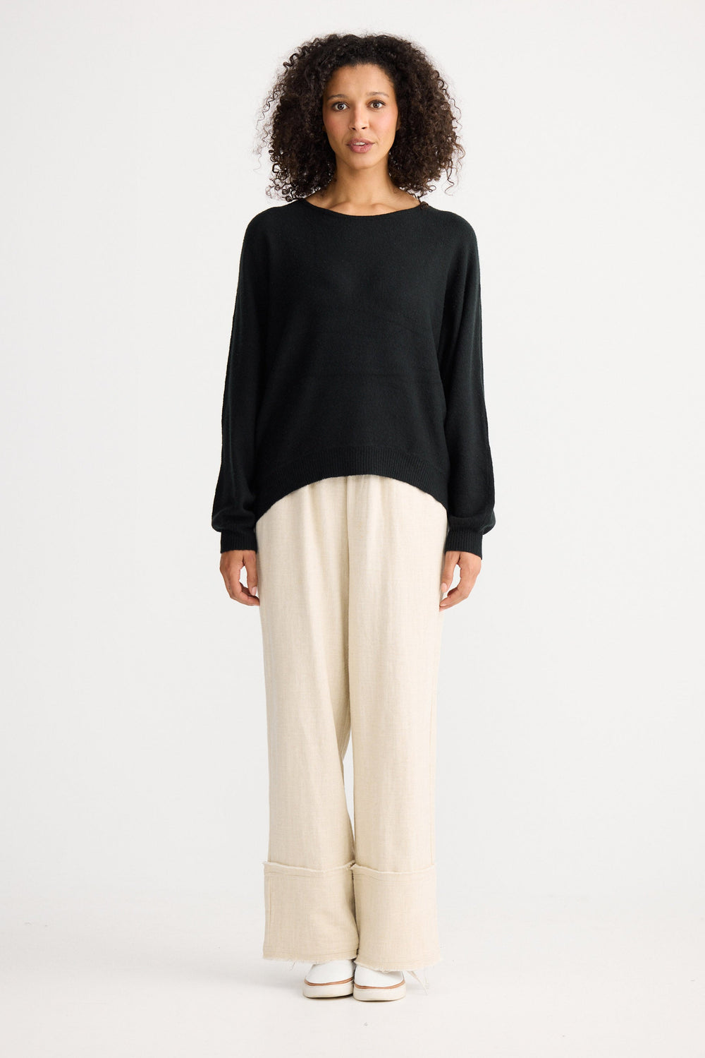 Model wearing charcoal Freddie Knit, back view on white background