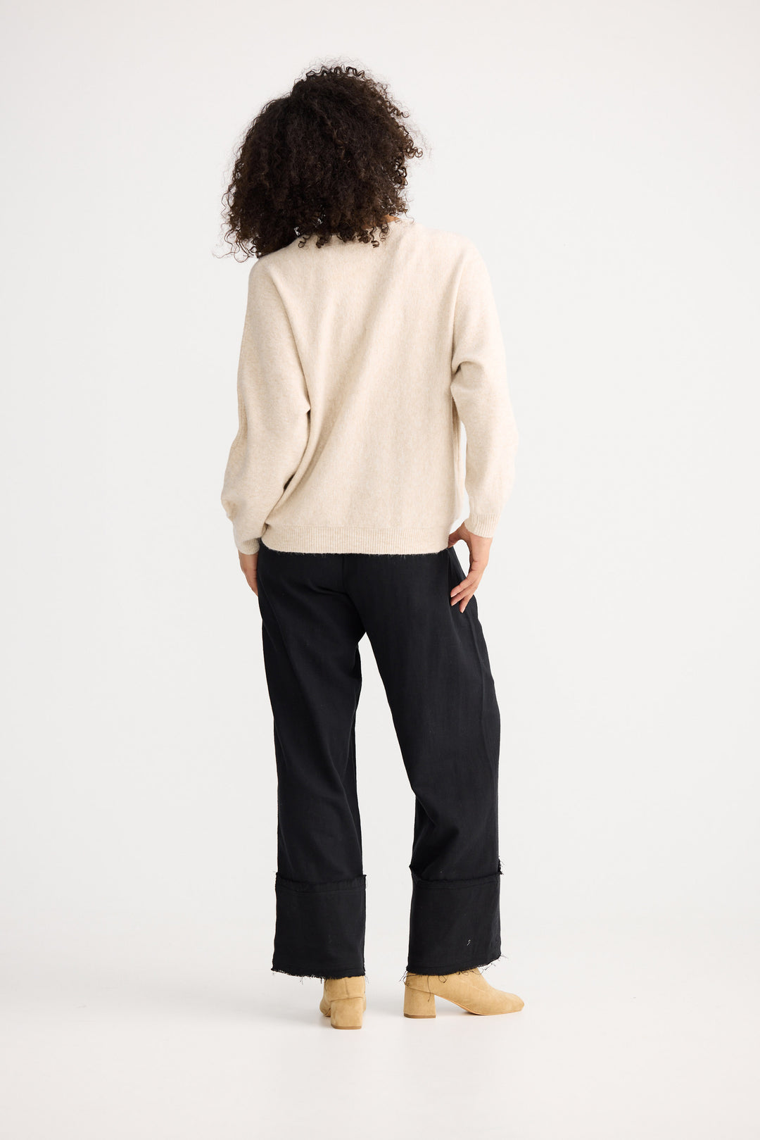 Model wearing oatmeal Freddie Knit, angled front view on white background