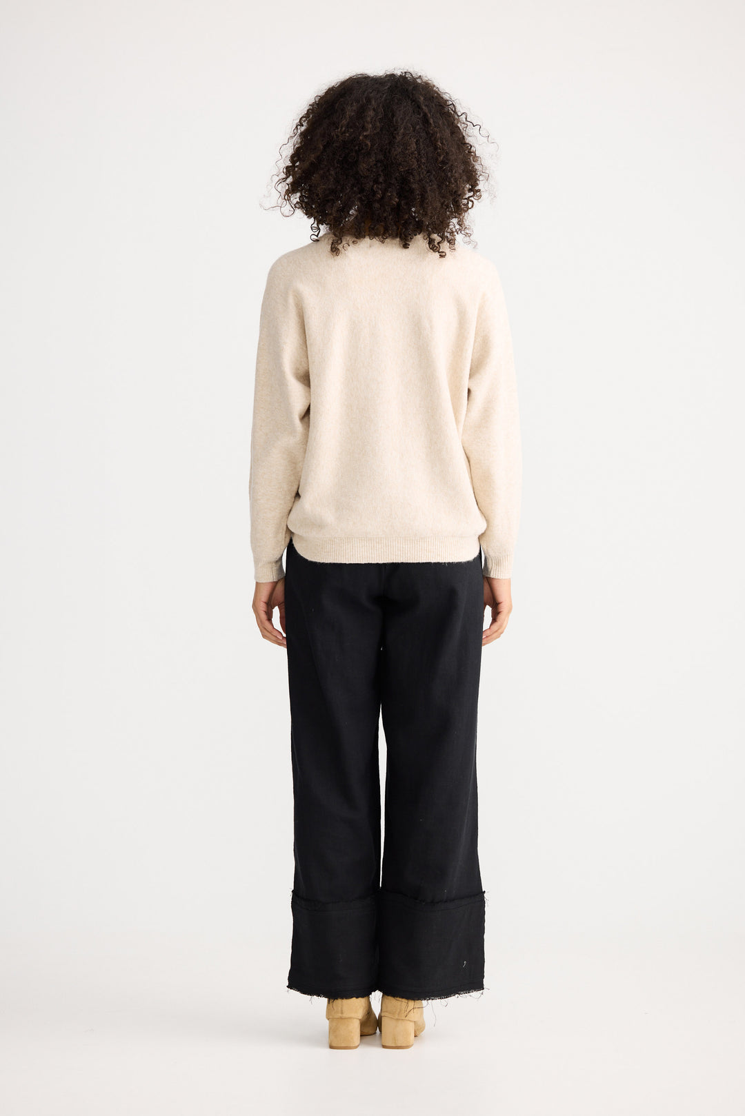 Model wearing oatmeal Freddie Knit, front view on white background