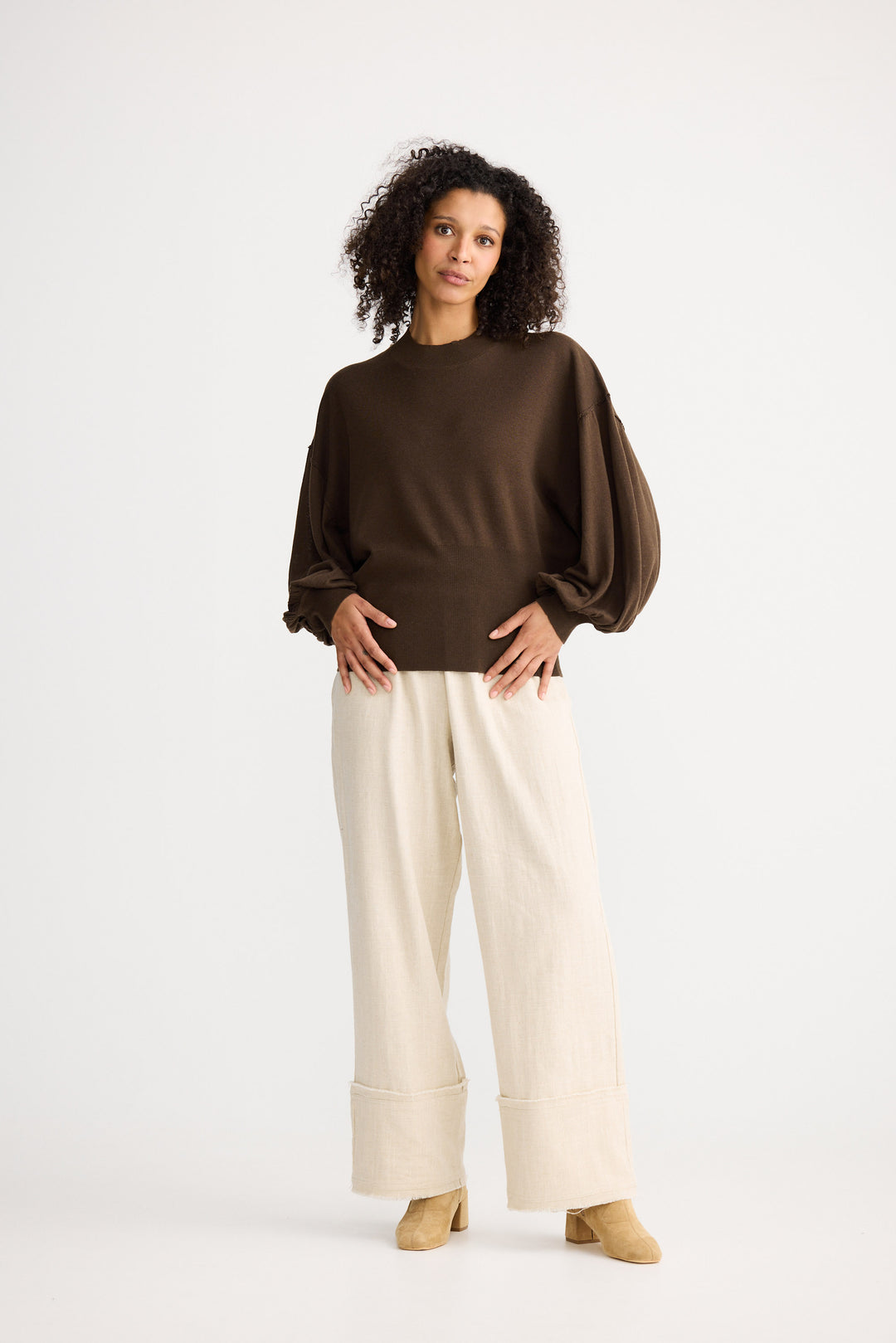 Model wearing chocolate Anais Knit Top, front view on white background