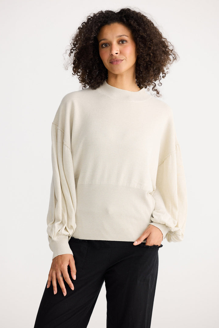 Model wearing oatmeal Anais Knit Top, back view on white background