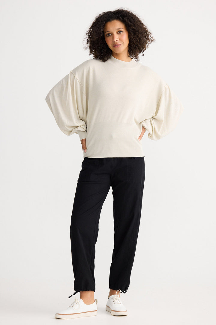 Model wearing oatmeal Anais Knit Top, angled front view on white background