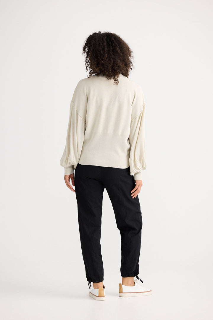 Model wearing oatmeal Anais Knit Top, front view on white background