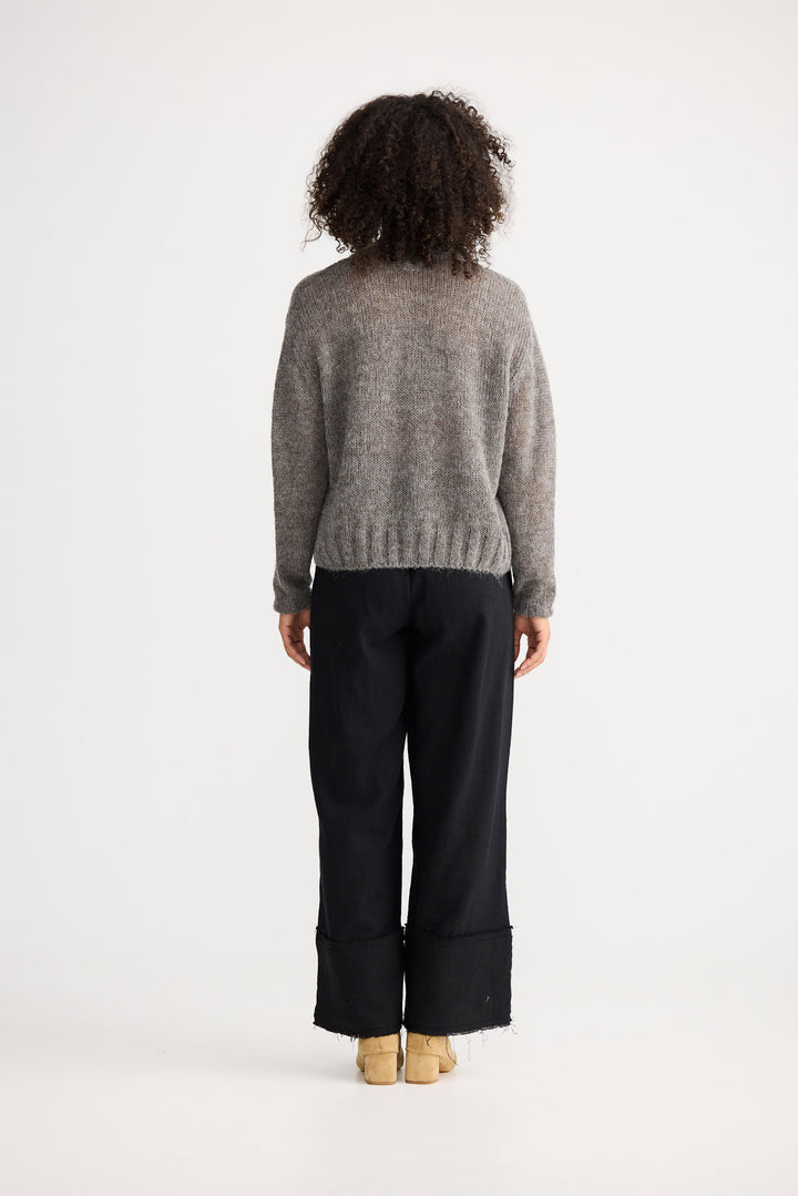 Model wearing charcoal Momento Knit, back view on white background