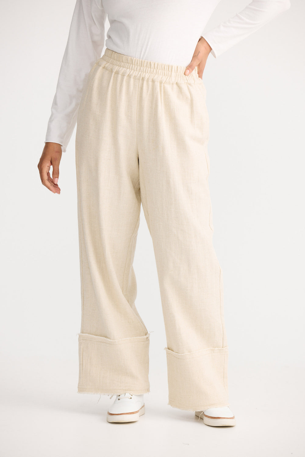 Model wearing natural Cadiz Pant, back view on white background