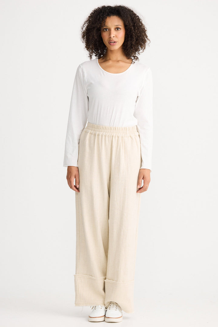 Model wearing natural Cadiz Pant, angled front view on white background