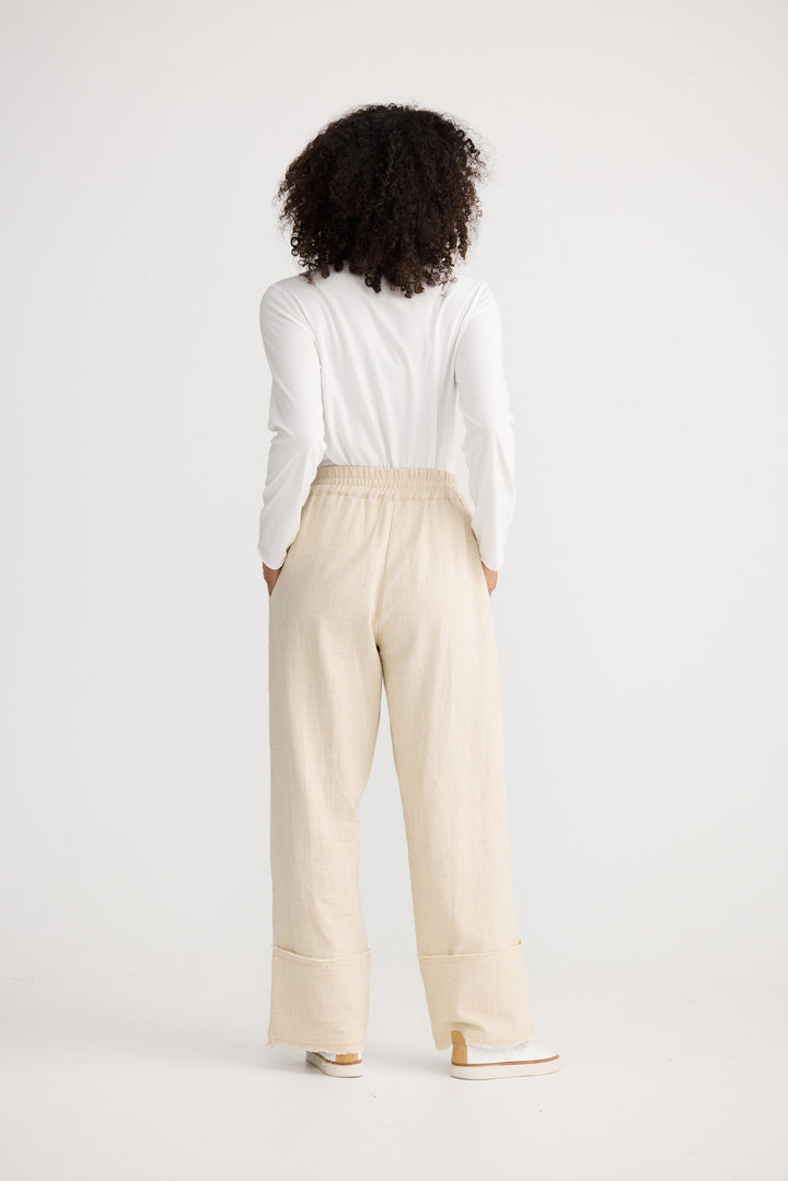 Model wearing natural Cadiz Pant, front view on white background