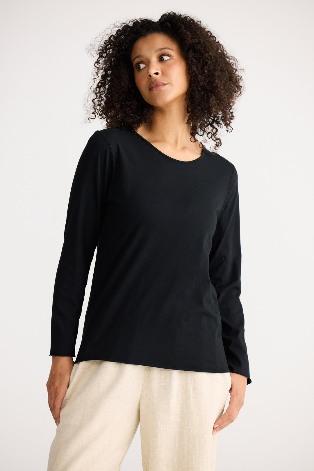 Model wearing black Kasai Long Sleeve Top, back view on white background