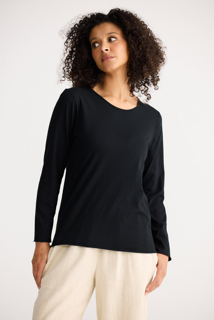 Model wearing black Kasai Long Sleeve Top, back view on white background