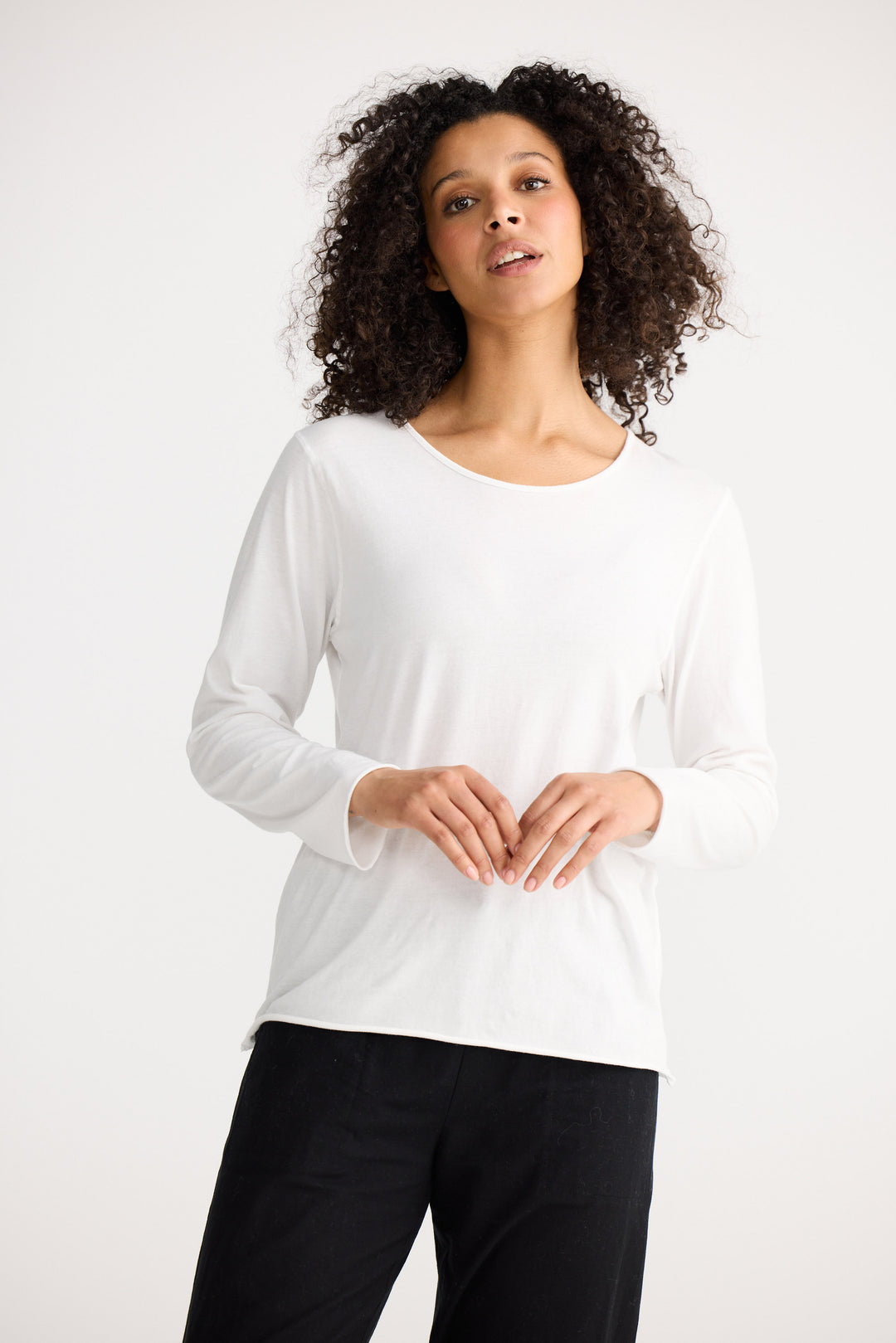 Model wearing ivory Kasai Long Sleeve Top, back view on white background