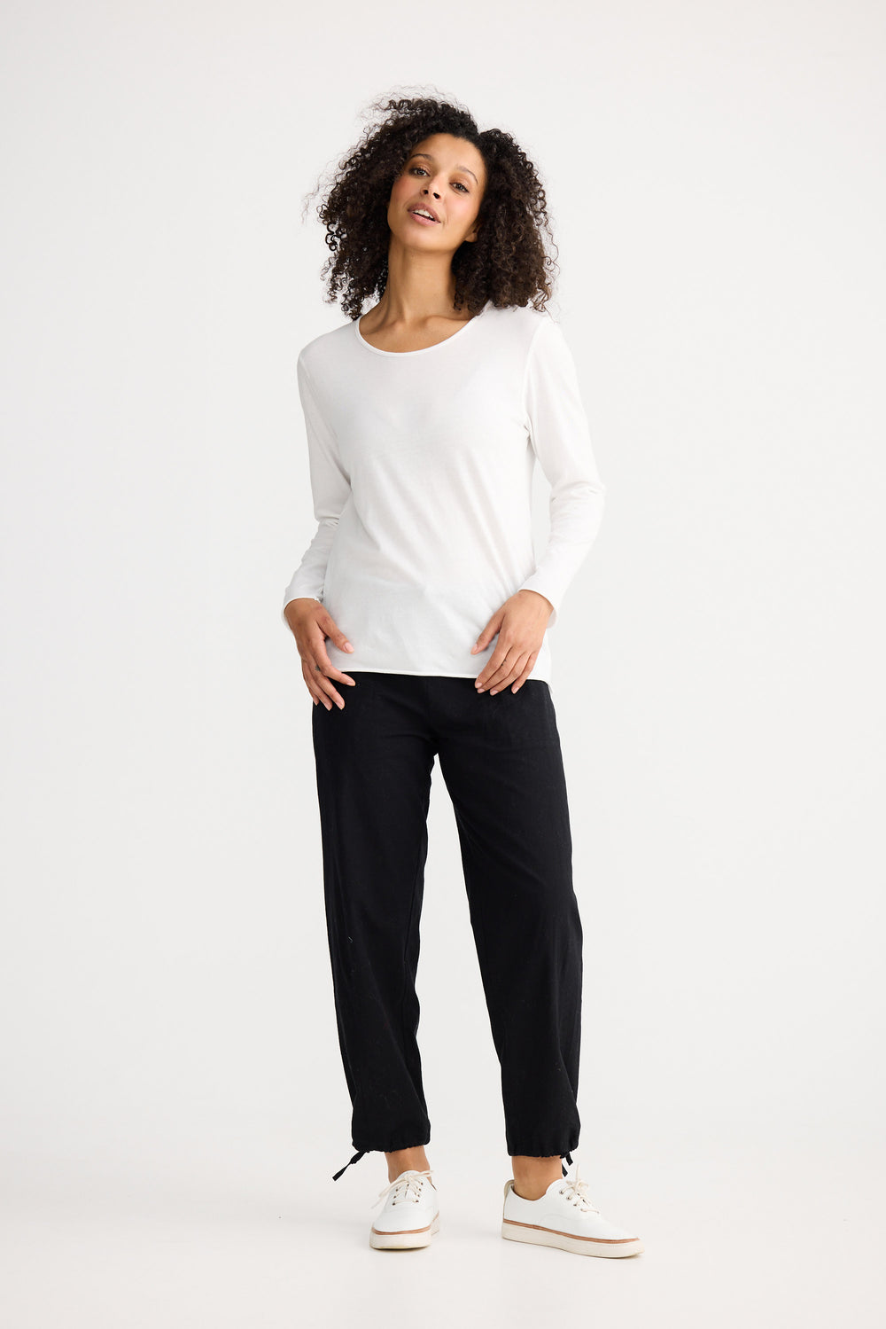 Model wearing ivory Kasai Long Sleeve Top, angled front view on white background