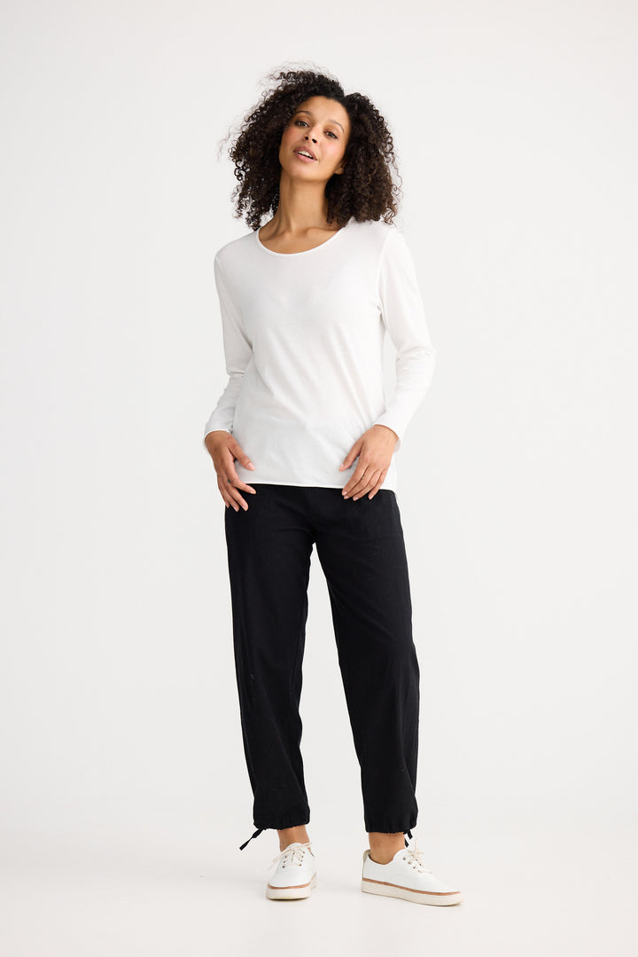 Model wearing ivory Kasai Long Sleeve Top, angled front view on white background