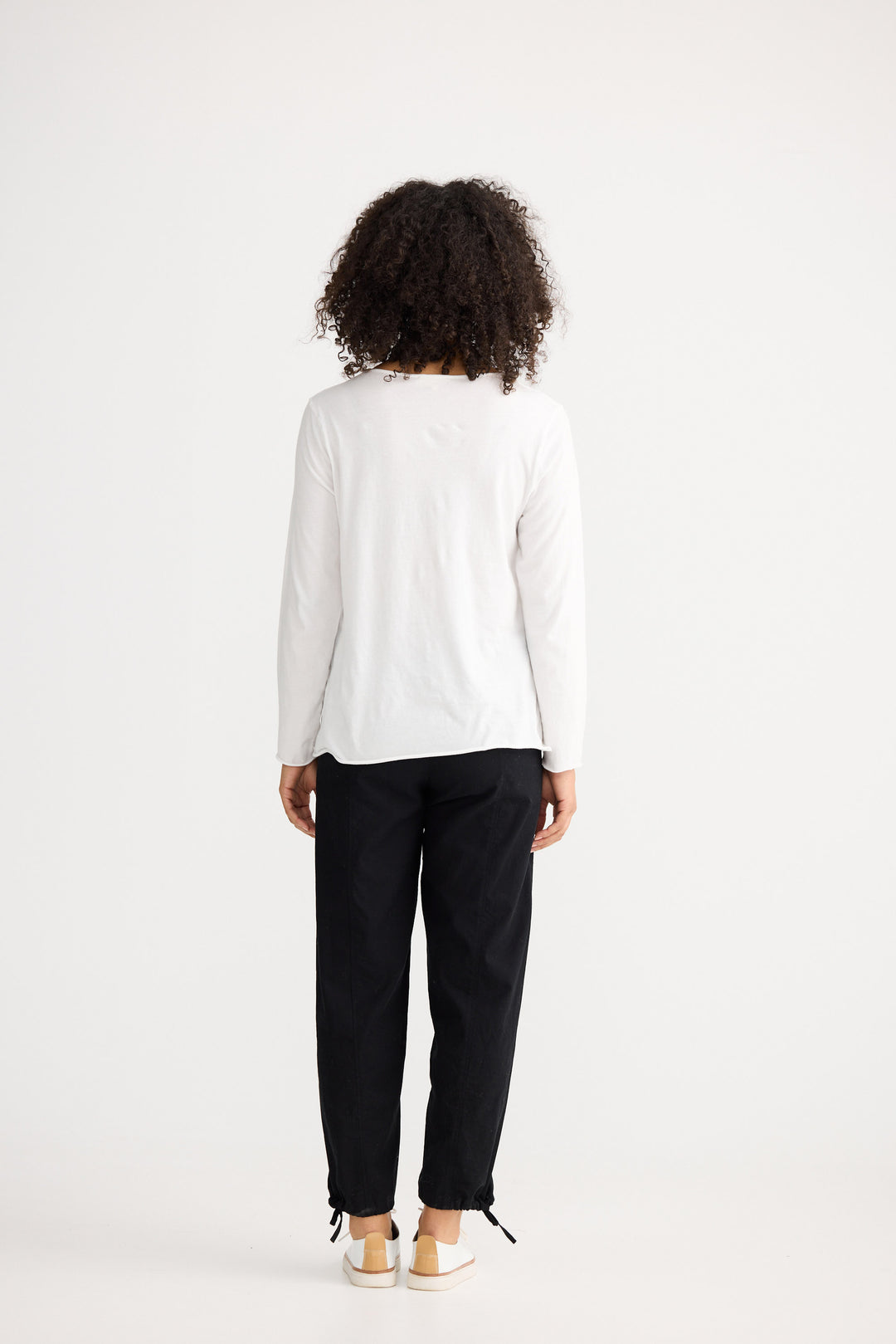 Model wearing ivory Kasai Long Sleeve Top, front view on white background