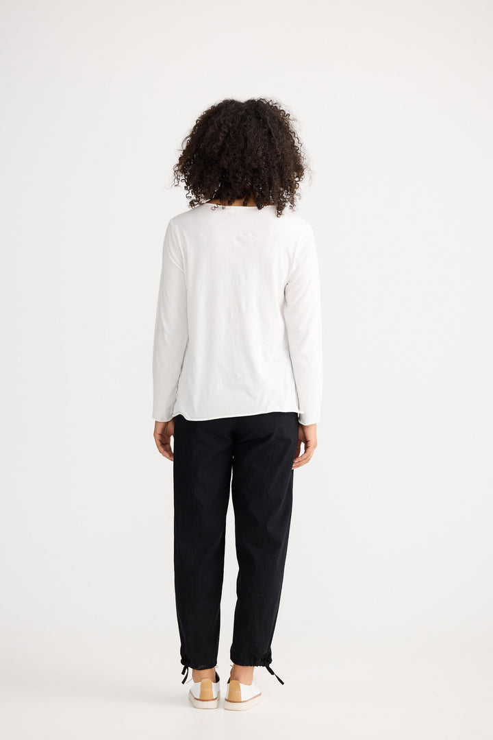 Model wearing ivory Kasai Long Sleeve Top, front view on white background