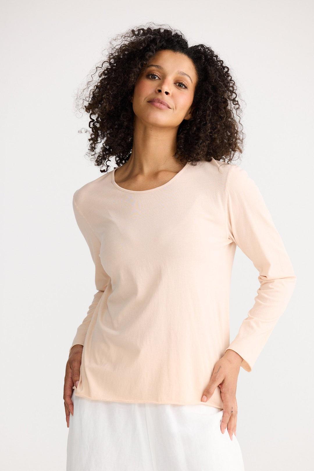 Model wearing peony Kasai Long Sleeve Top, angled front view on white background