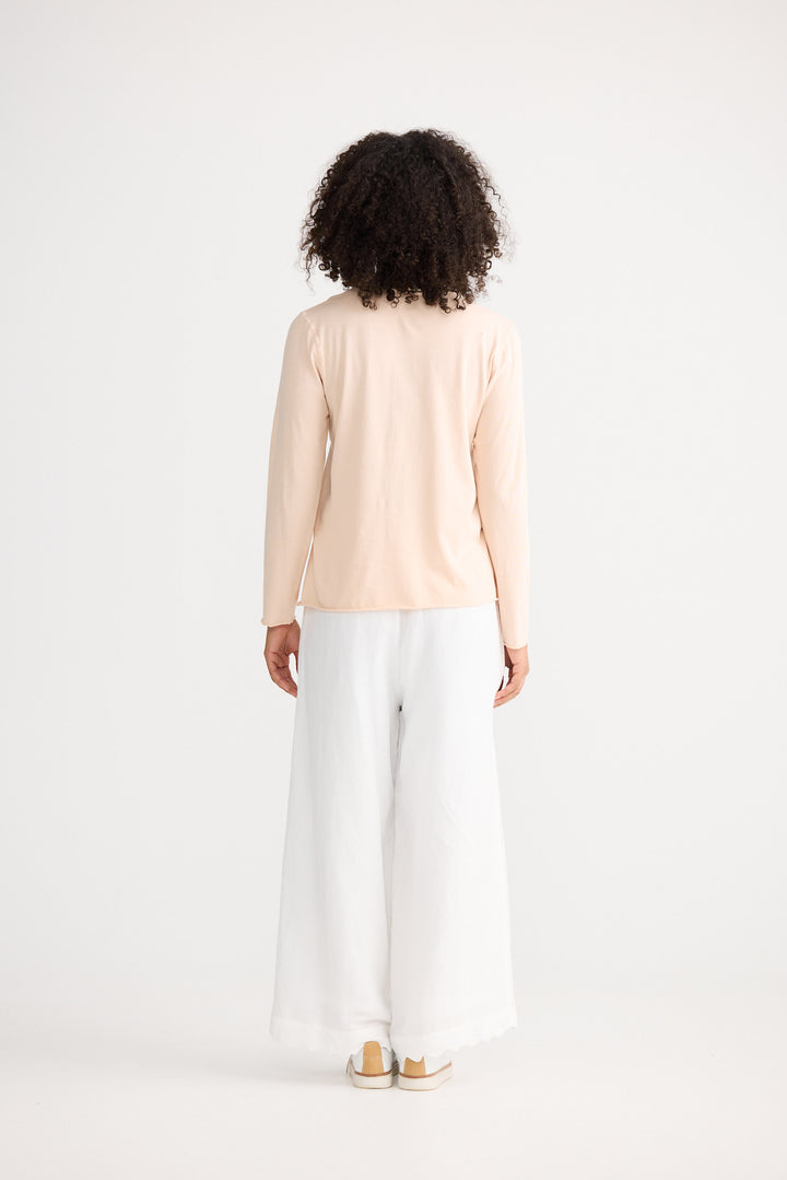 Model wearing peony Kasai Long Sleeve Top, back view on white background