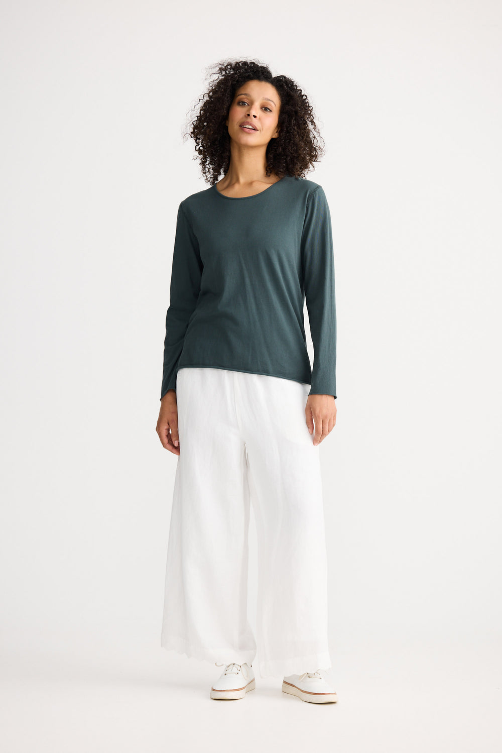 Model wearing slate Kasai Long Sleeve Top, front view on white background
