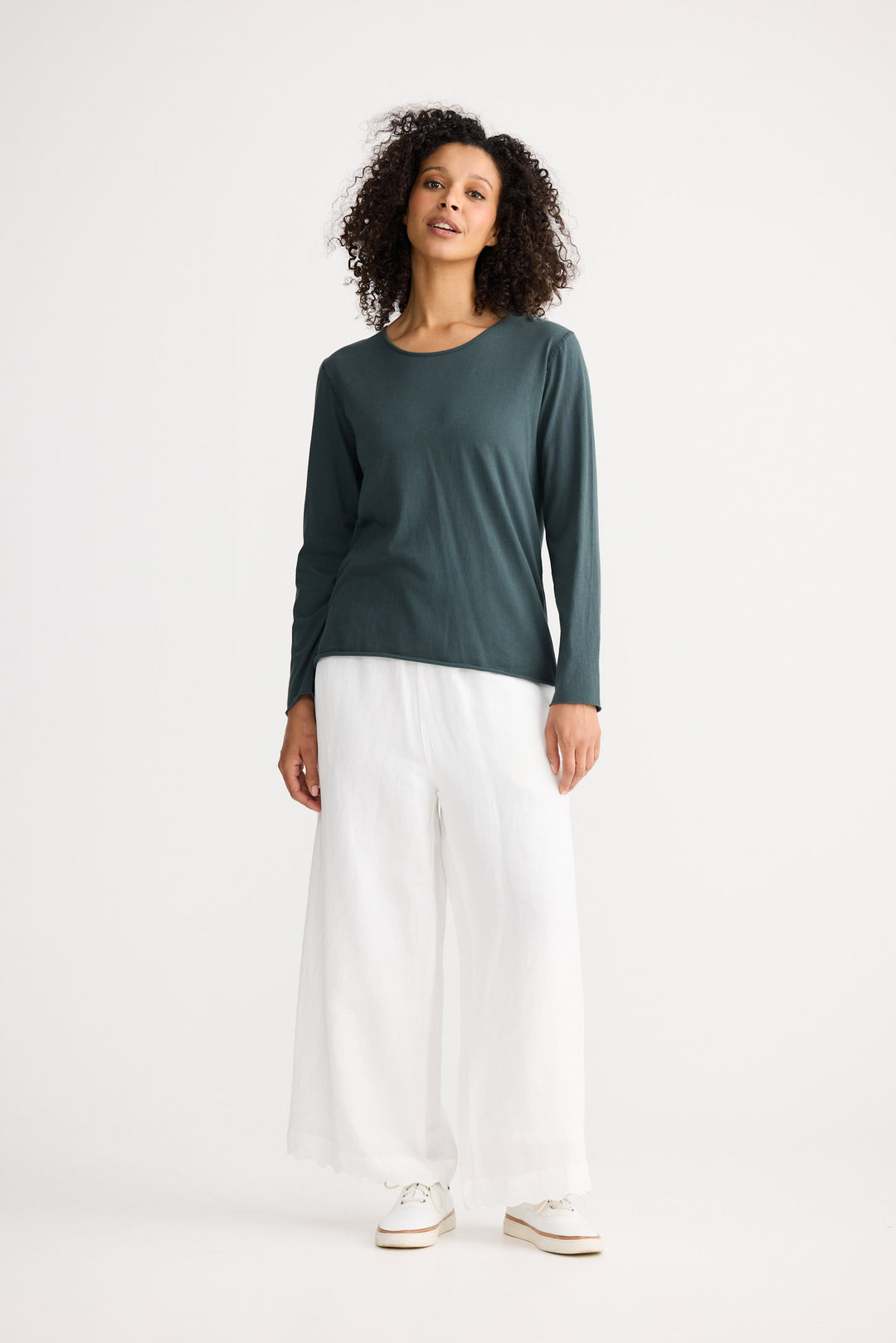 Model wearing slate Kasai Long Sleeve Top, front view on white background