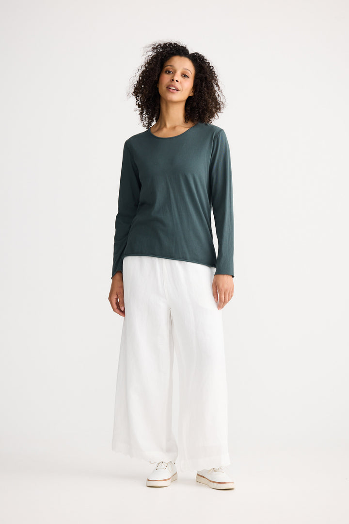 Model wearing slate Kasai Long Sleeve Top, front view on white background