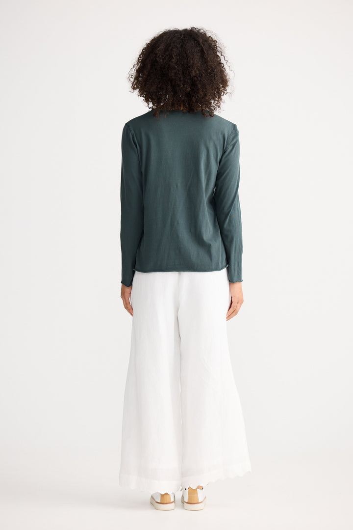 Model wearing slate Kasai Long Sleeve Top, side view on white background
