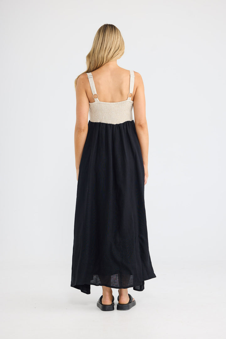 Model wearing Britta Dress in black with natural, front view.
