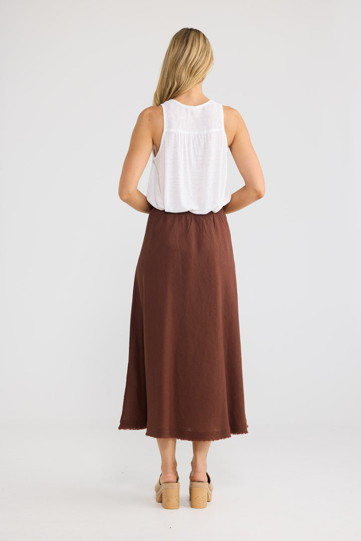 Model wearing Sicily Skirt in chocolate linen, front view.