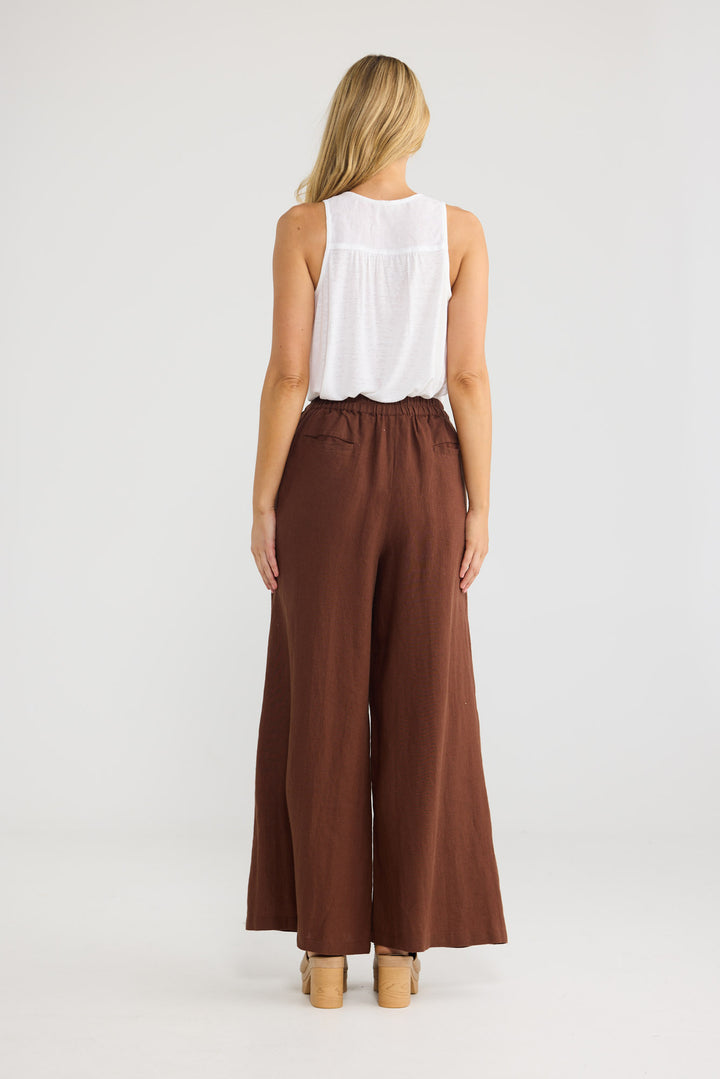 Model wearing Positano Pants in chocolate linen, front view.