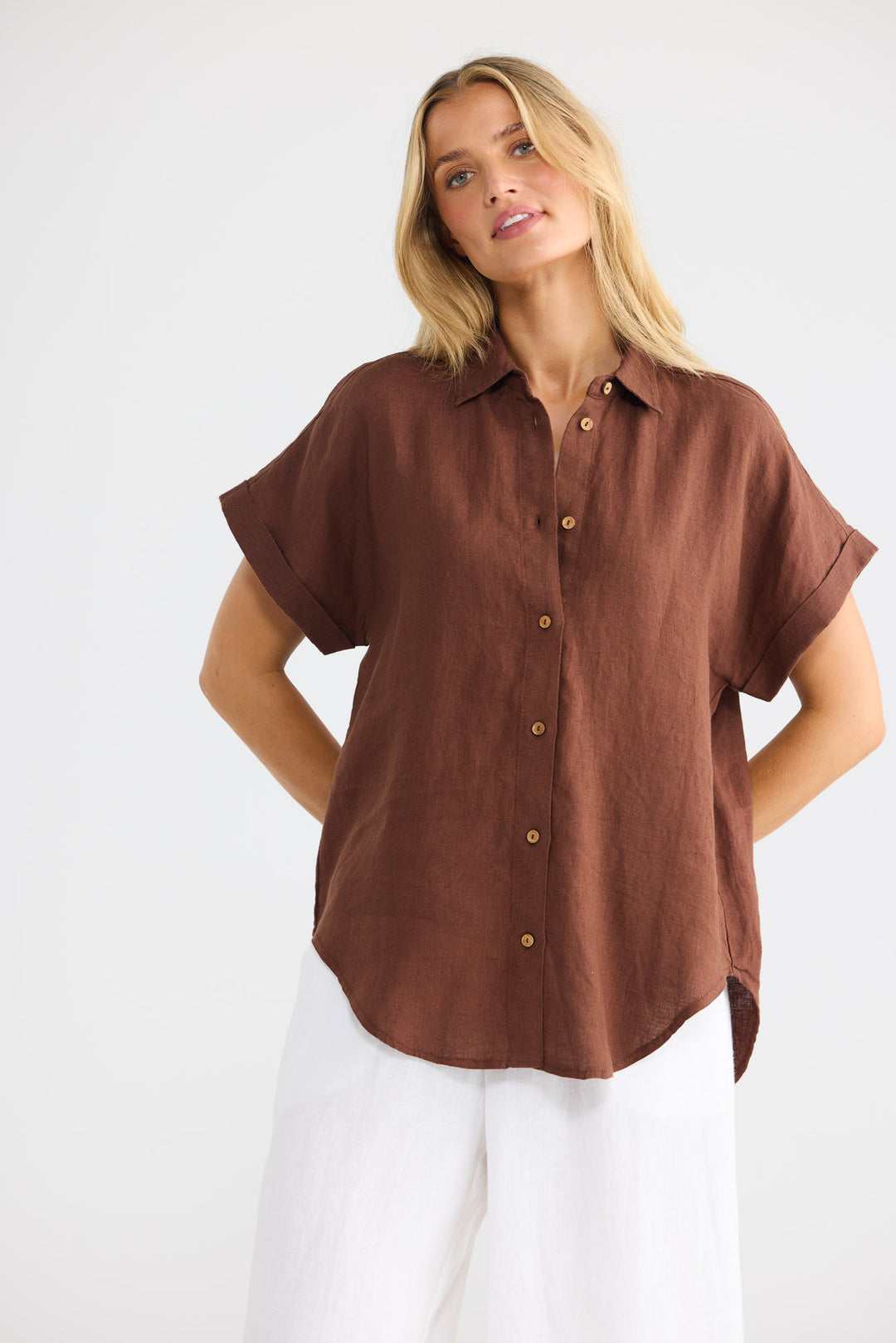 Model wearing Dune Shirt in chocolate linen, front view.