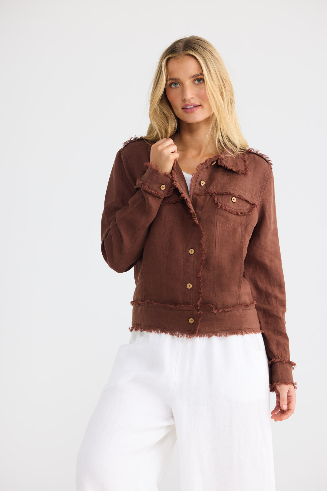 Model wearing Monza Jacket in chocolate linen with frayed trim, front view.