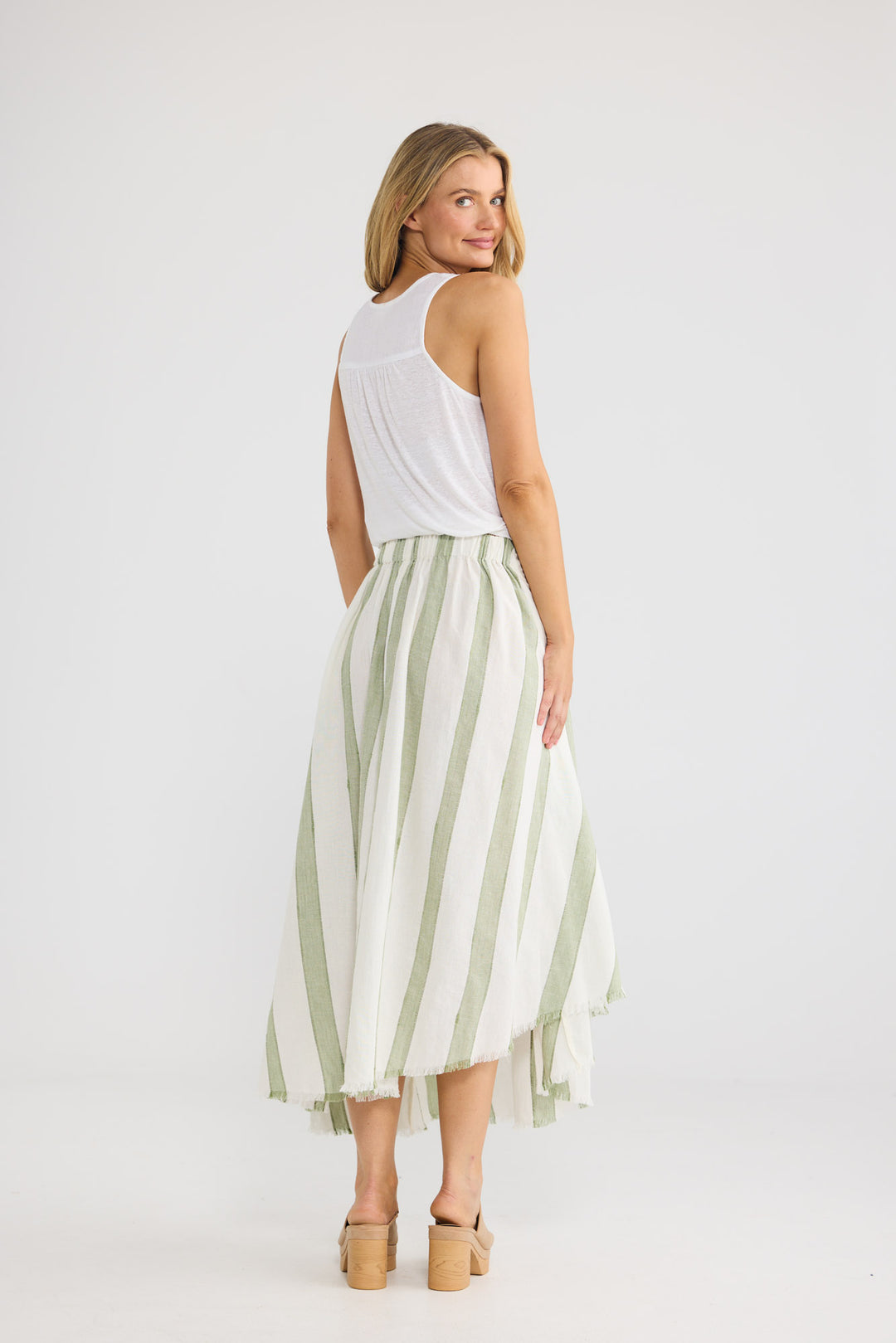 The Edit Skirt in Sage Shadow Stripe with a waist sash.