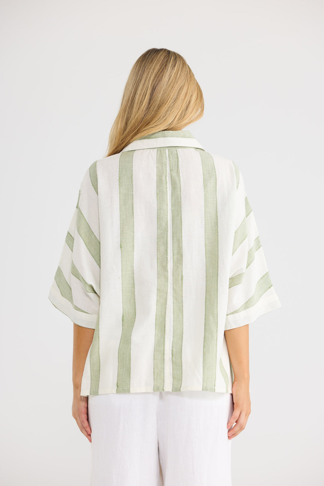 Model wearing Wander Top in Sage Shadow Stripe, front view.