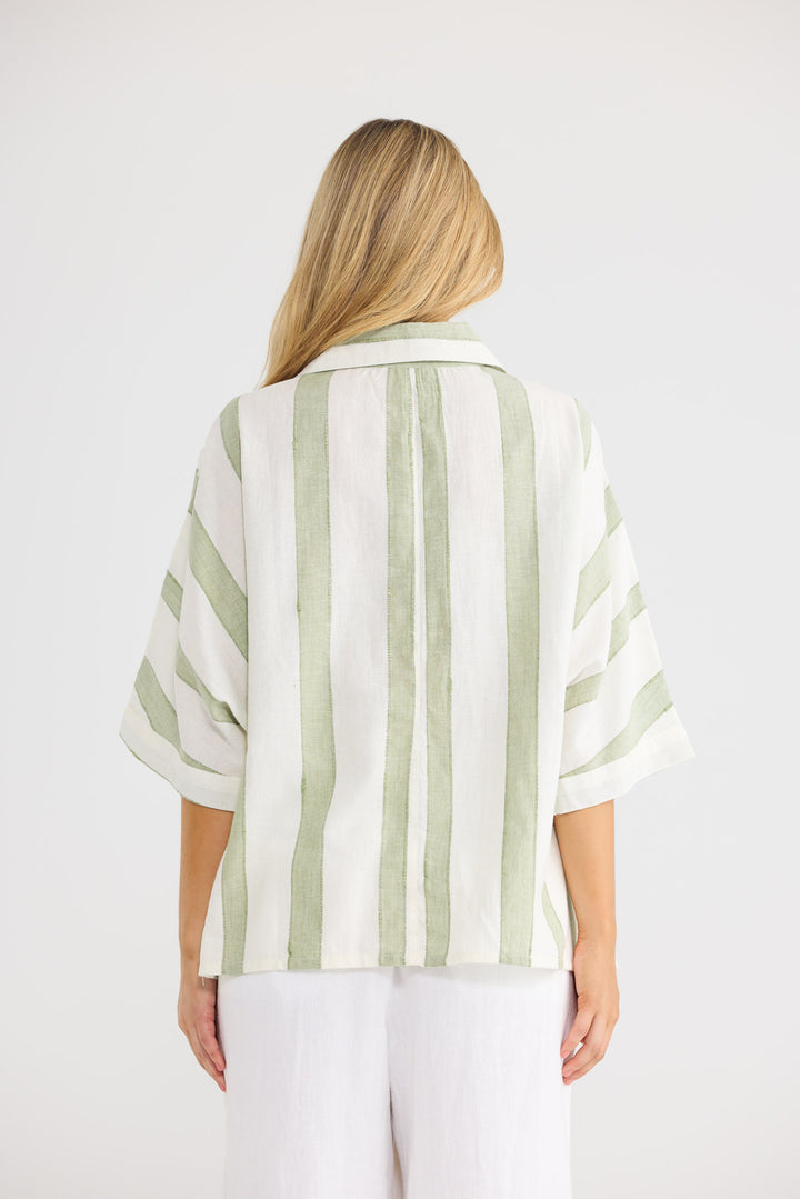 Model wearing Wander Top in Sage Shadow Stripe, front view.