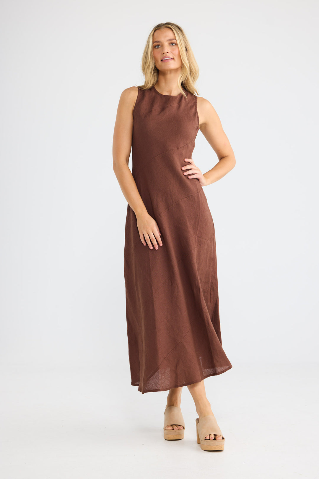 Model wearing Dickens Dress in chocolate linen, front view.