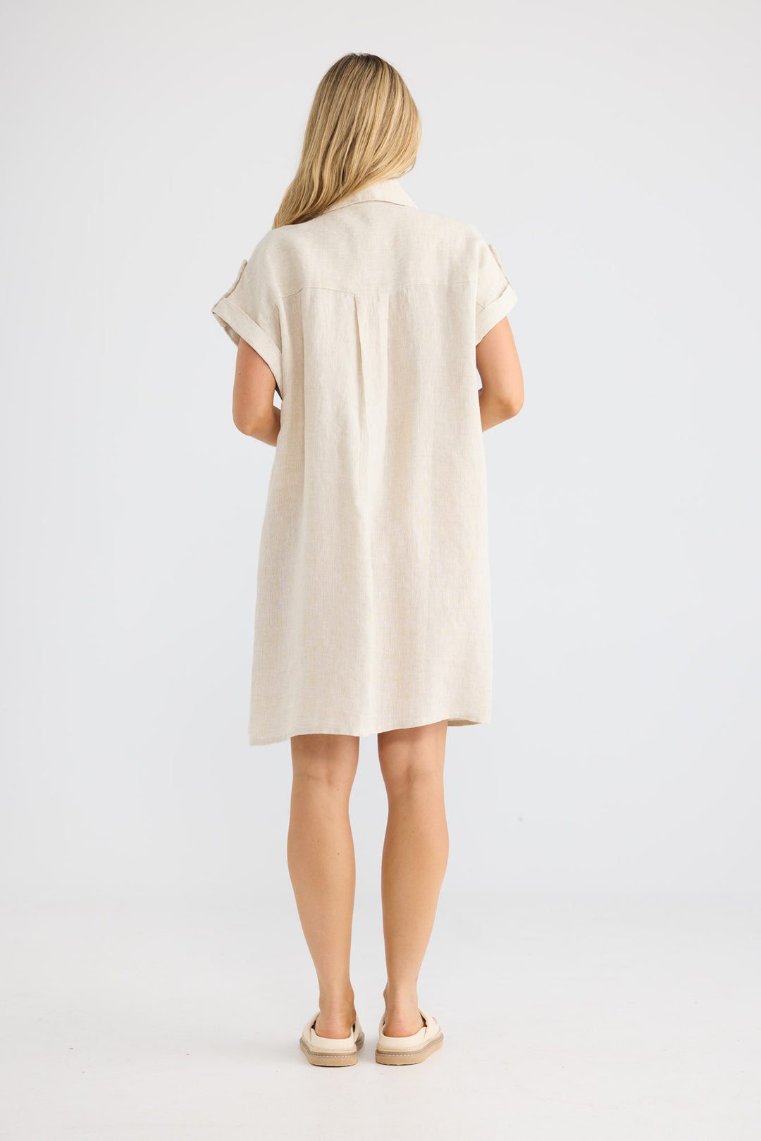 Model wearing Errance Dress in natural linen, front view.