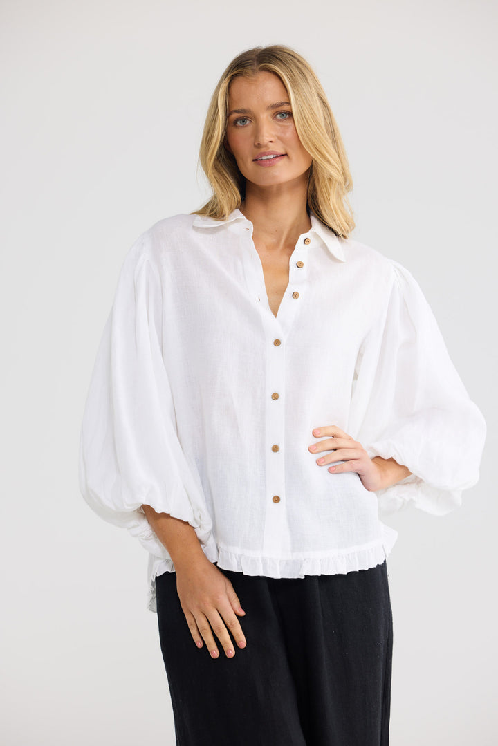 Model wearing Alina Shirt in white linen, front view.